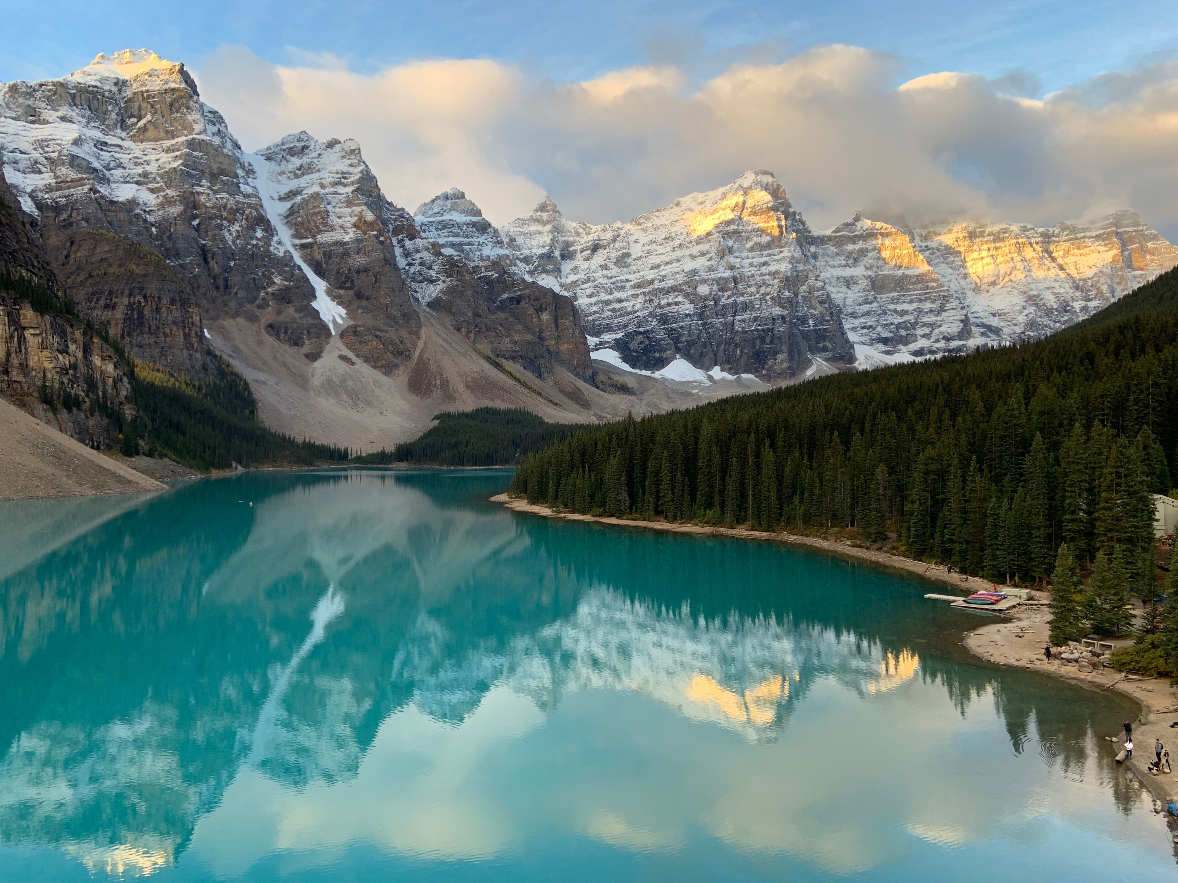 Free Breathtaking reflection of the Canadian Rockies in the turquoise waters of Lake Louise at dawn. Stock Photo
