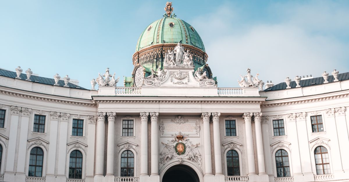 Elegant view of the Hofburg Palace's dome and facade in Vienna, Austria under a clear sky.
