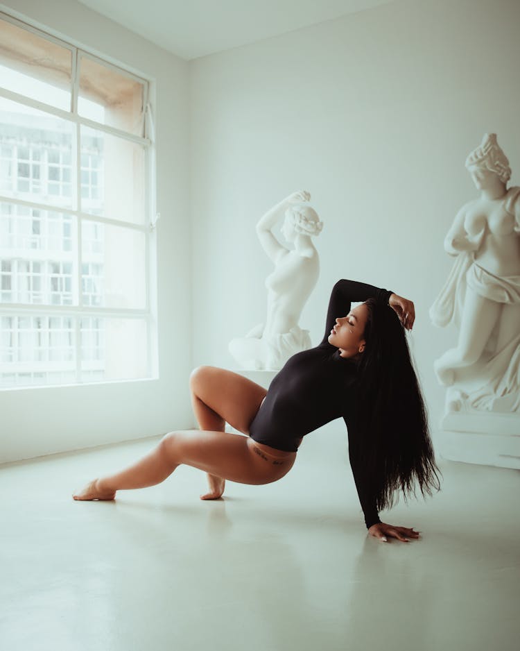 Woman In A Black Leotard Dancing On The Floor 