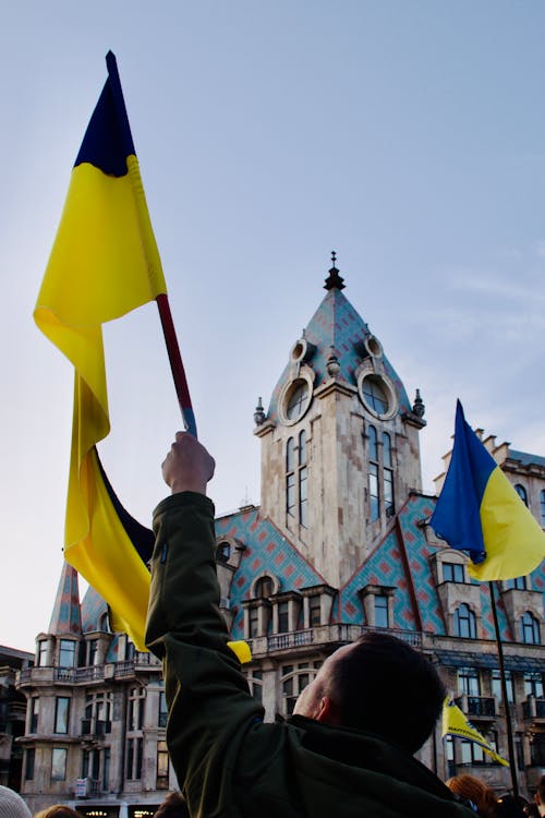 People Holding Ukrainian Flags in Munich 