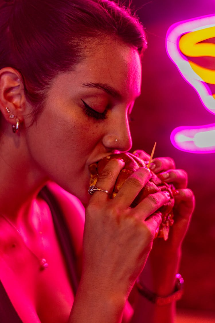 A Woman Eating A Burger 