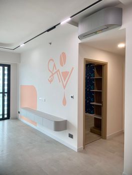 Bright and open modern interior with wall art and shelving, featuring pastel colors and minimalist design.