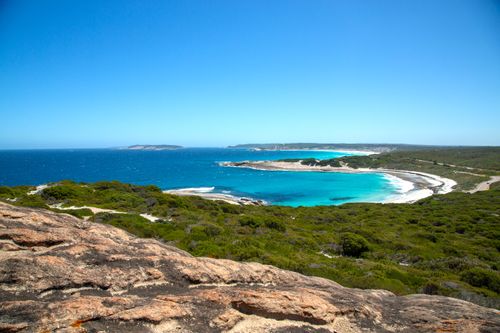 Free Aerial view of a breathtaking coastal bay with turquoise waters and lush green vegetation. Stock Photo