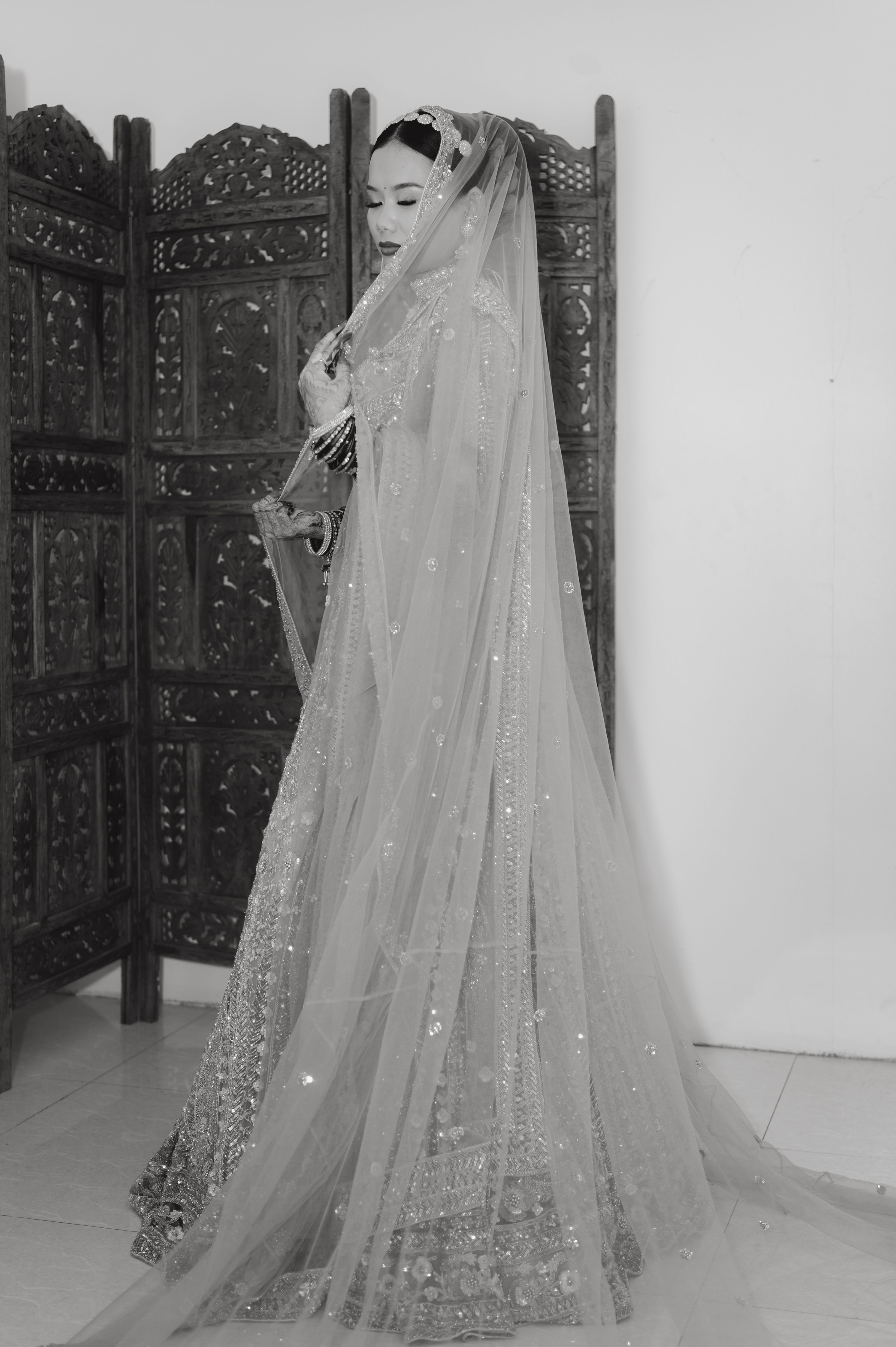 A woman in a veil standing in front of a wall · Free Stock Photo