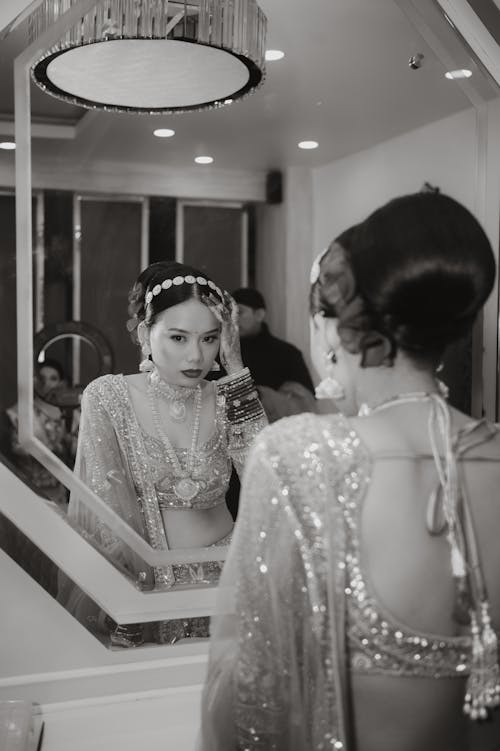 Bride in Traditional Clothing Standing by Mirror 