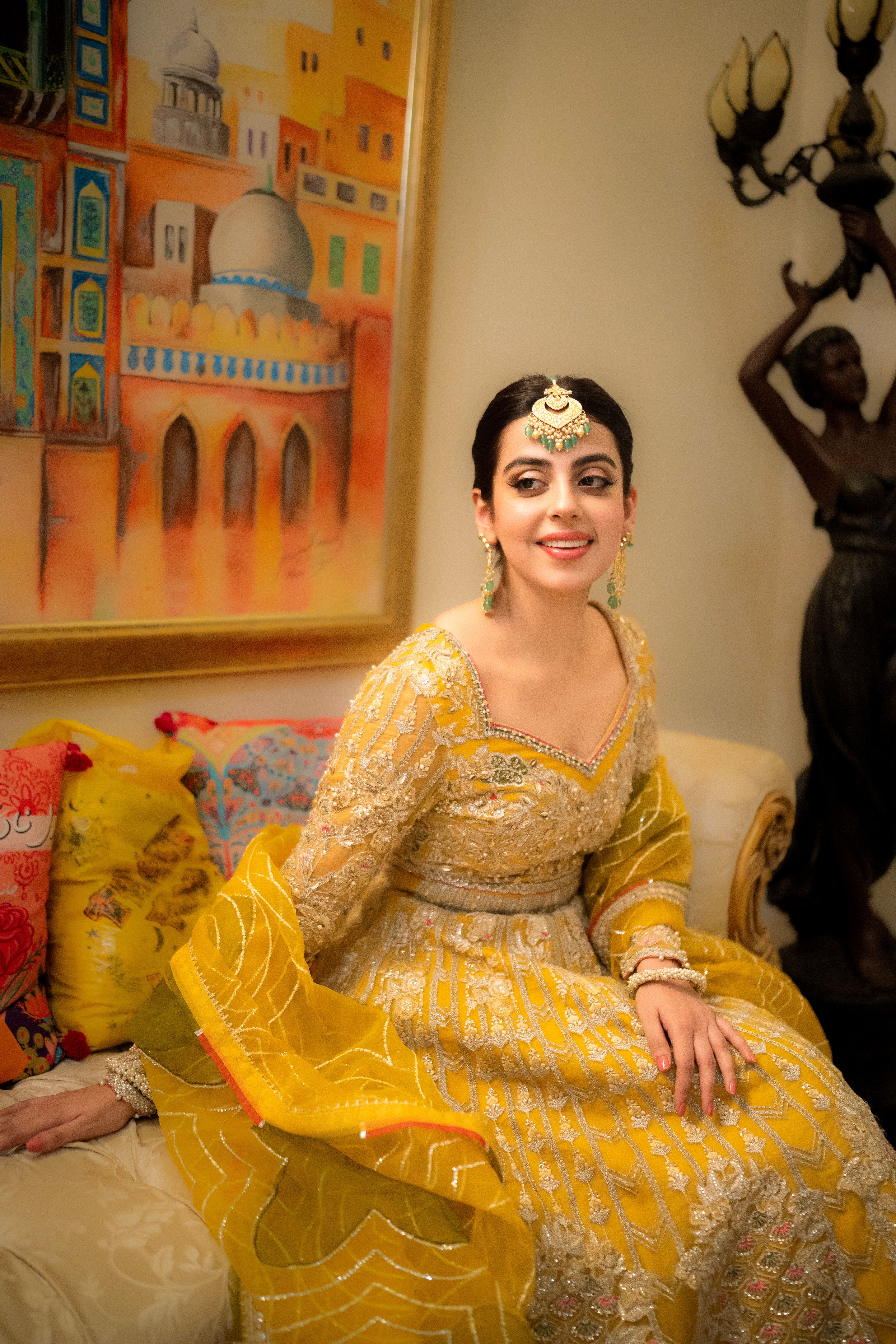 Woman in Traditional Clothing Sitting on Couch · Free Stock Photo