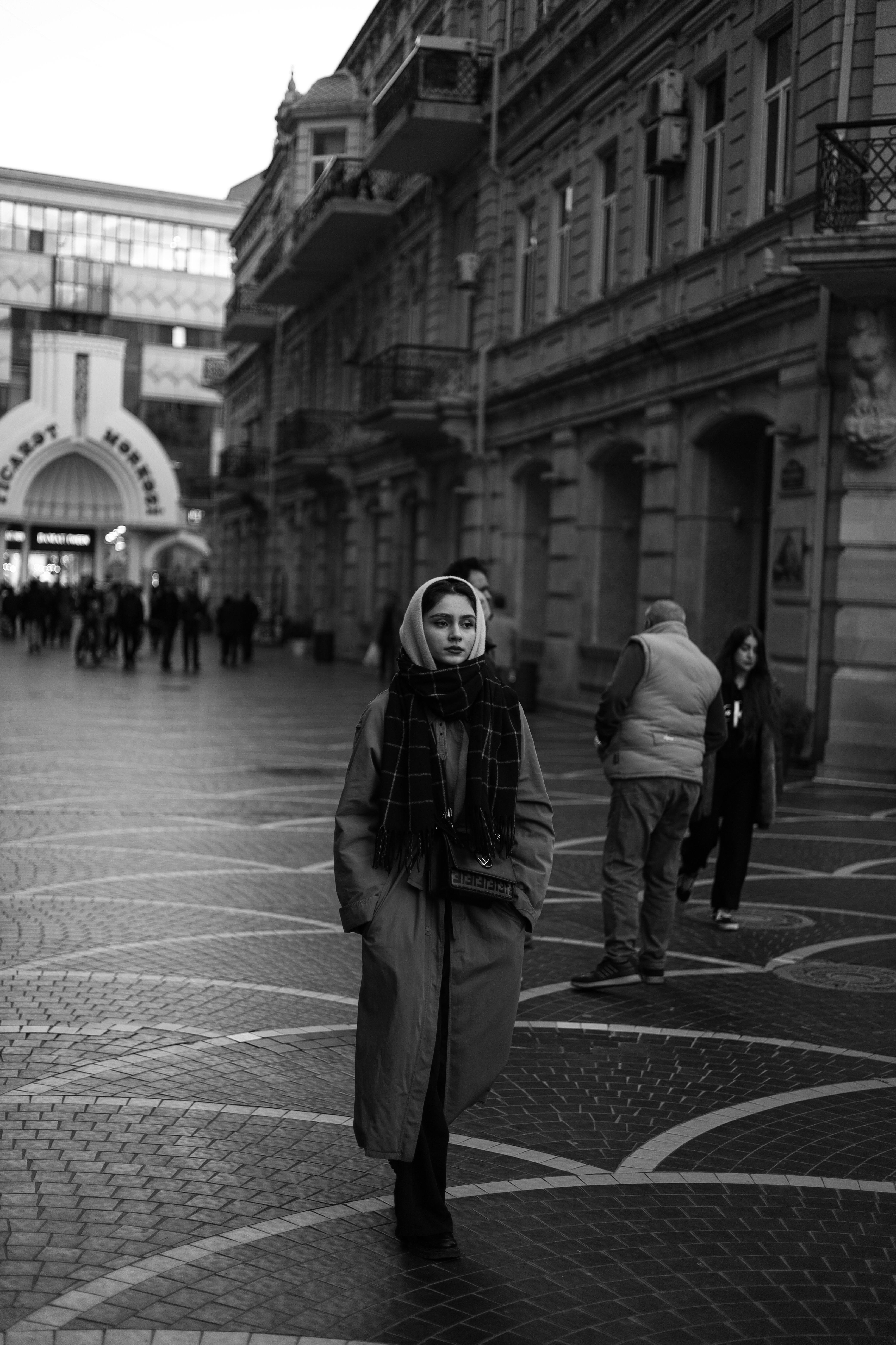 A woman in a headscarf walks along a historic street in Baku, Azerbaijan.