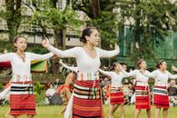 Group of women performing a traditional dance in colorful costumes, celebrating cultural heritage.