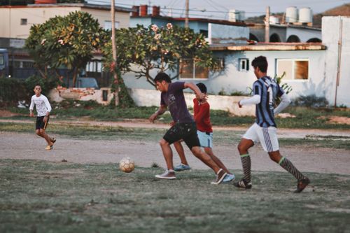 Free A group of boys play football on an informal field in a town setting. Stock Photo