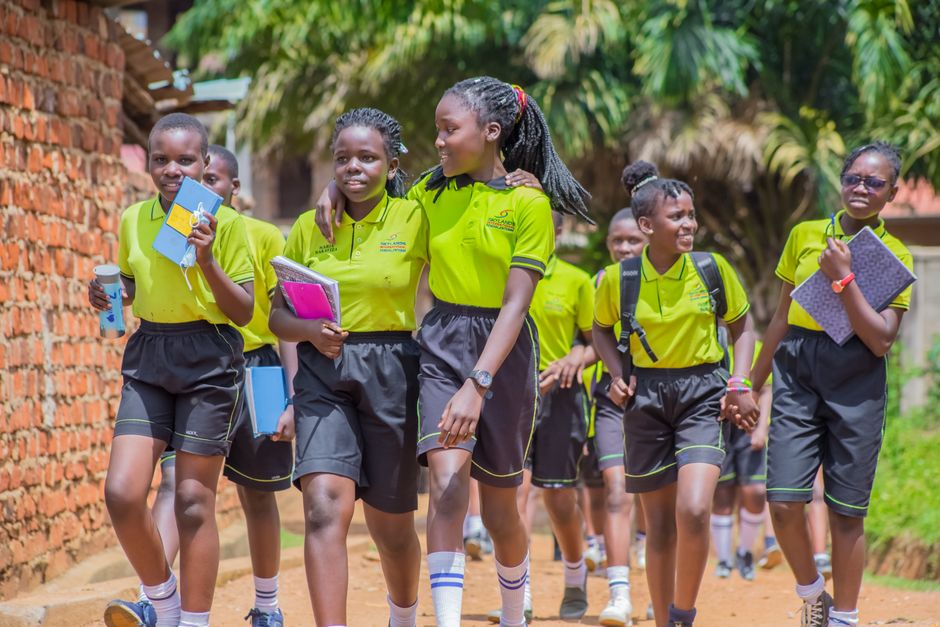 Students in school uniforms walking in Uganda