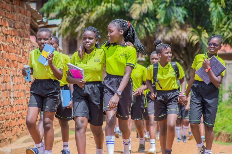 African children in school uniforms studying together outdoors in Kenya