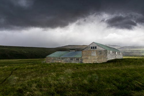 Barn and House under Overcast Sky