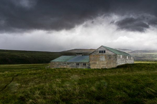 Solitary barn beneath a dramatic storm sky — photo by Dick Scholten on Pexels