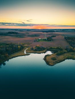 A tranquil aerial view of a Minnesota lakeshore at sunset, showcasing a rural landscape.