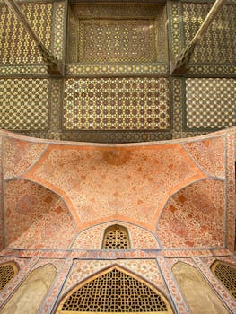 A detailed view of the ornate ceiling inside the Chehel Sotoun Palace in Isfahan, showcasing Persian art.