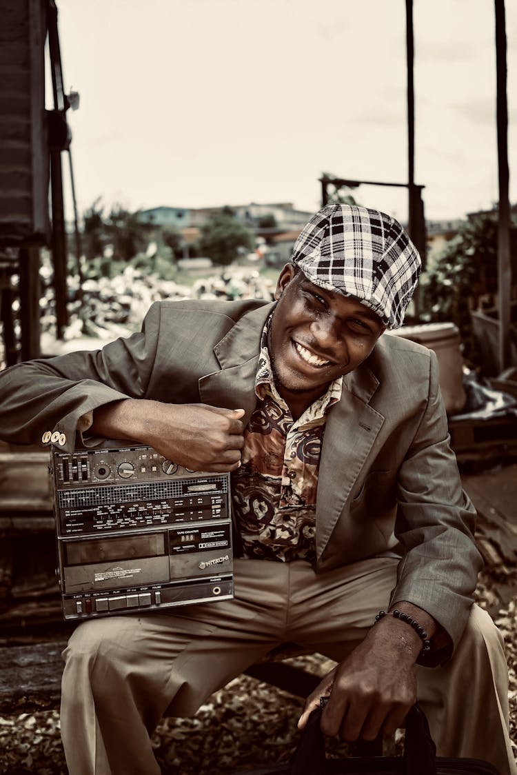 Smiling Man In Suit Sitting With Vintage Radio