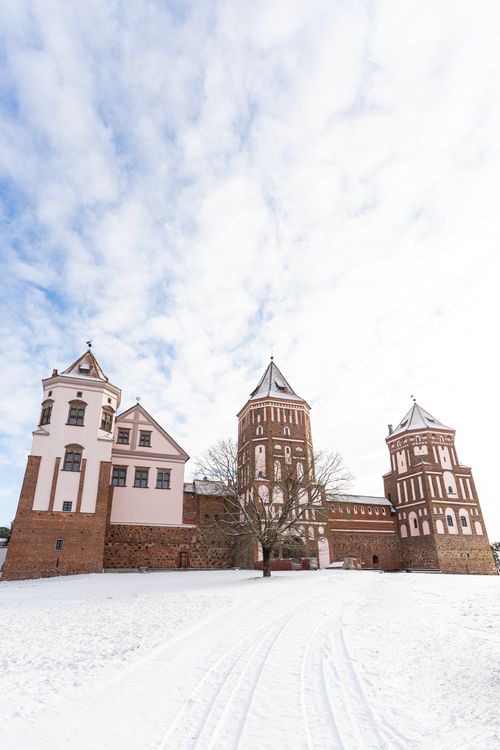 Free Stunning winter view of Mir Castle in Belarus, highlighting its historical architecture amid a snowy landscape. Stock Photo