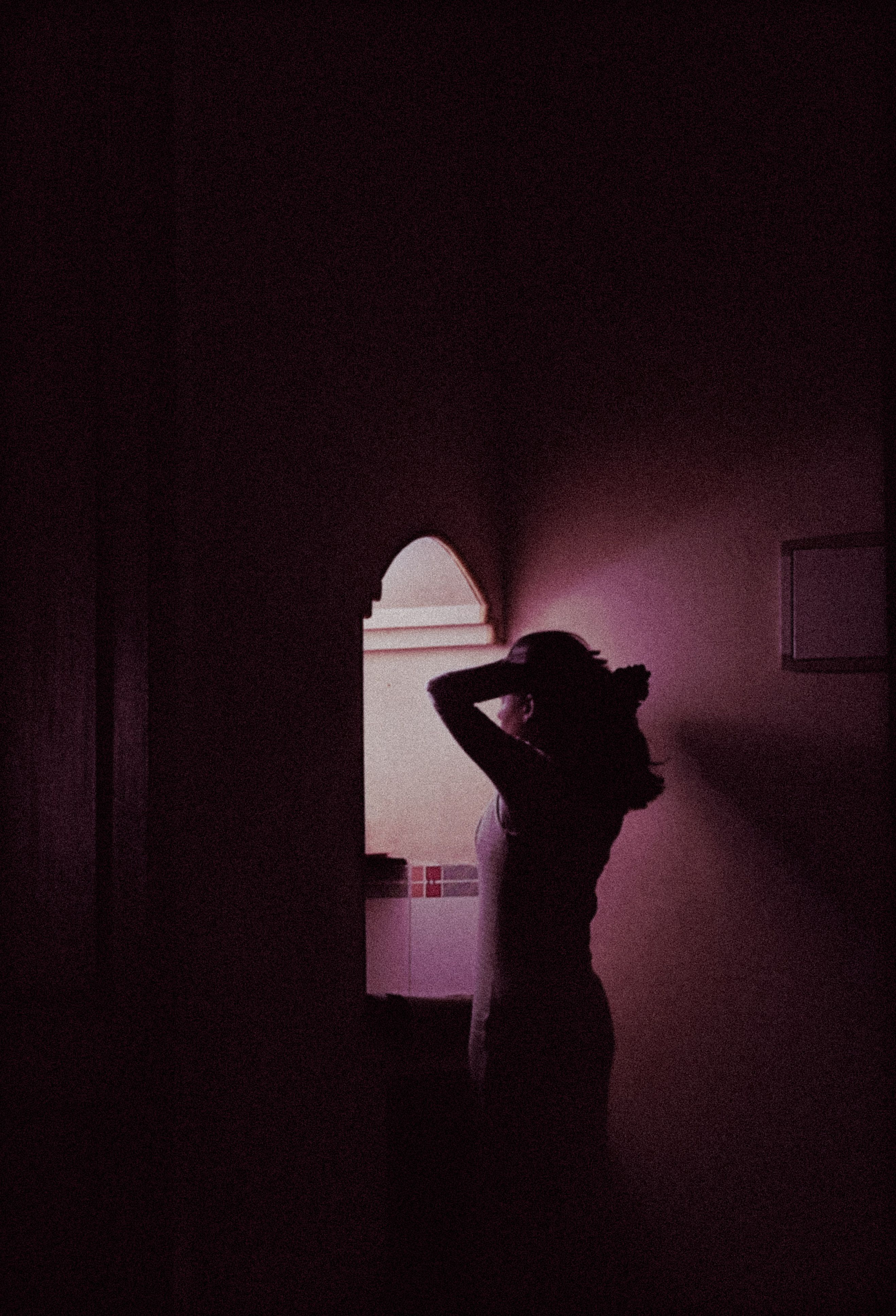 Silhouette of a Woman in a Dark Room · Free Stock Photo