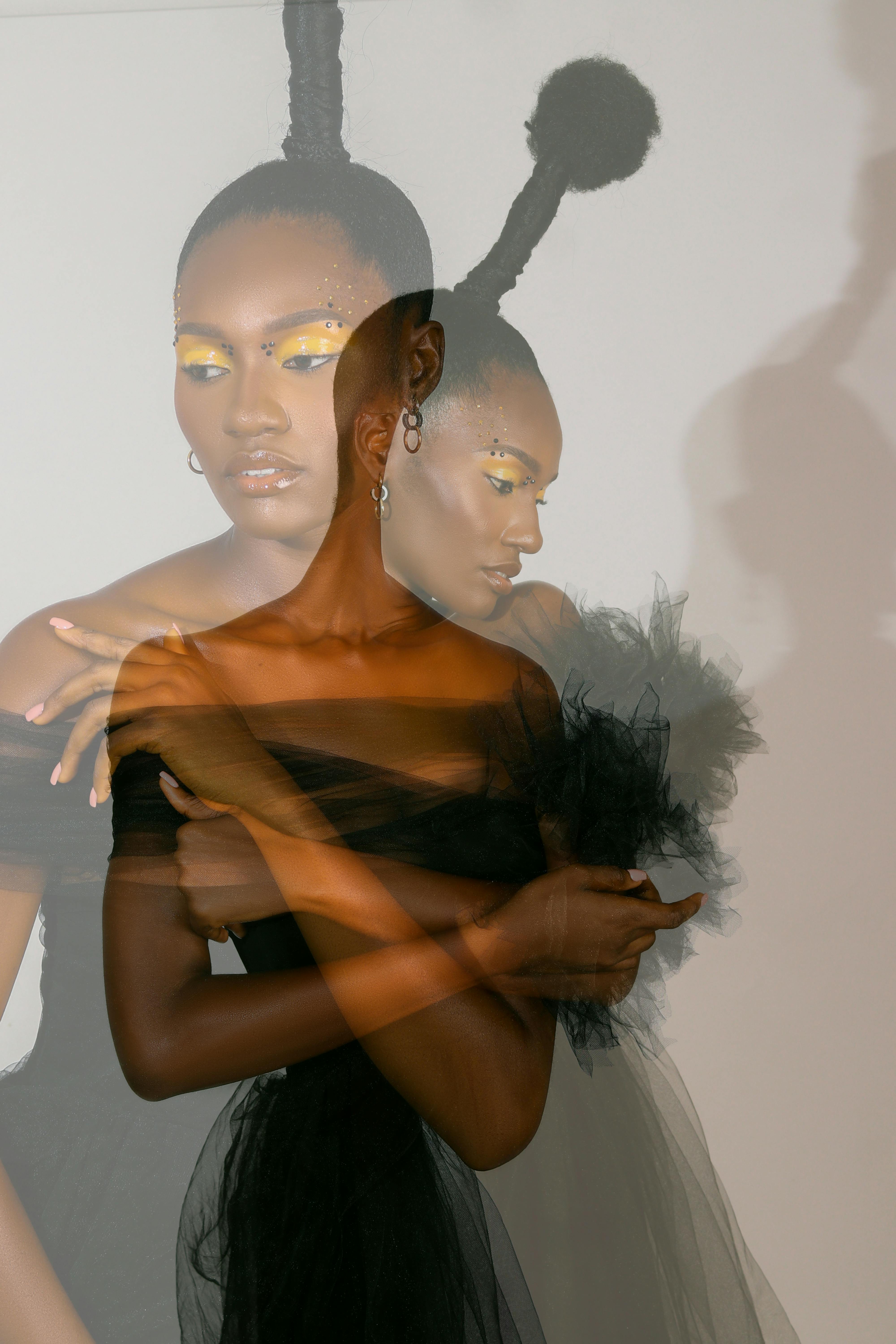 Fashion portrait of woman in black dress with creative hair and makeup, using double exposure technique.