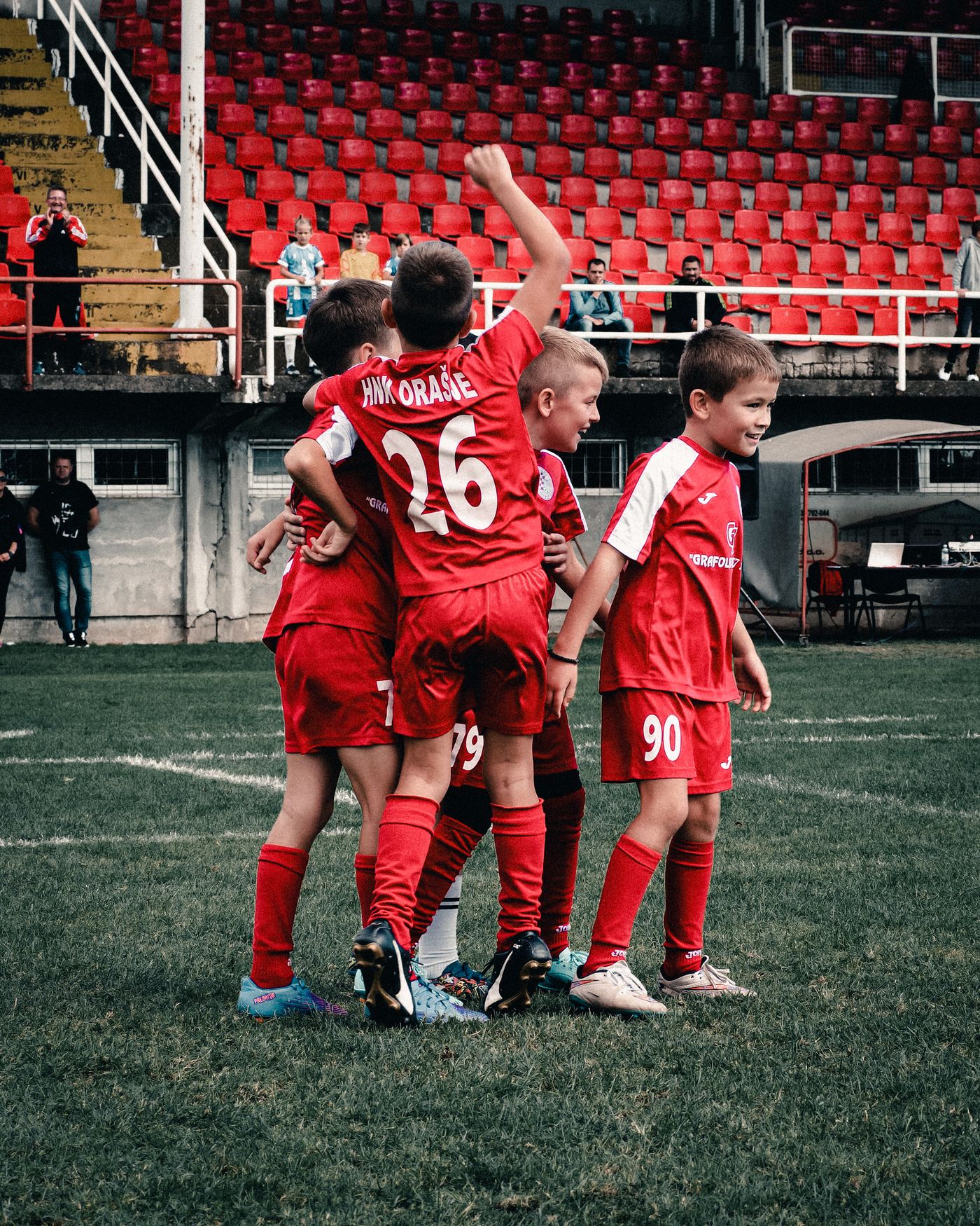 A group of young soccer players celebrating together on the field