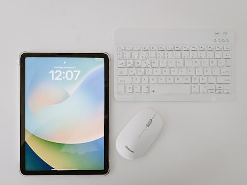 Philips Wireless Mouse and Keyboard Next to the Tablet