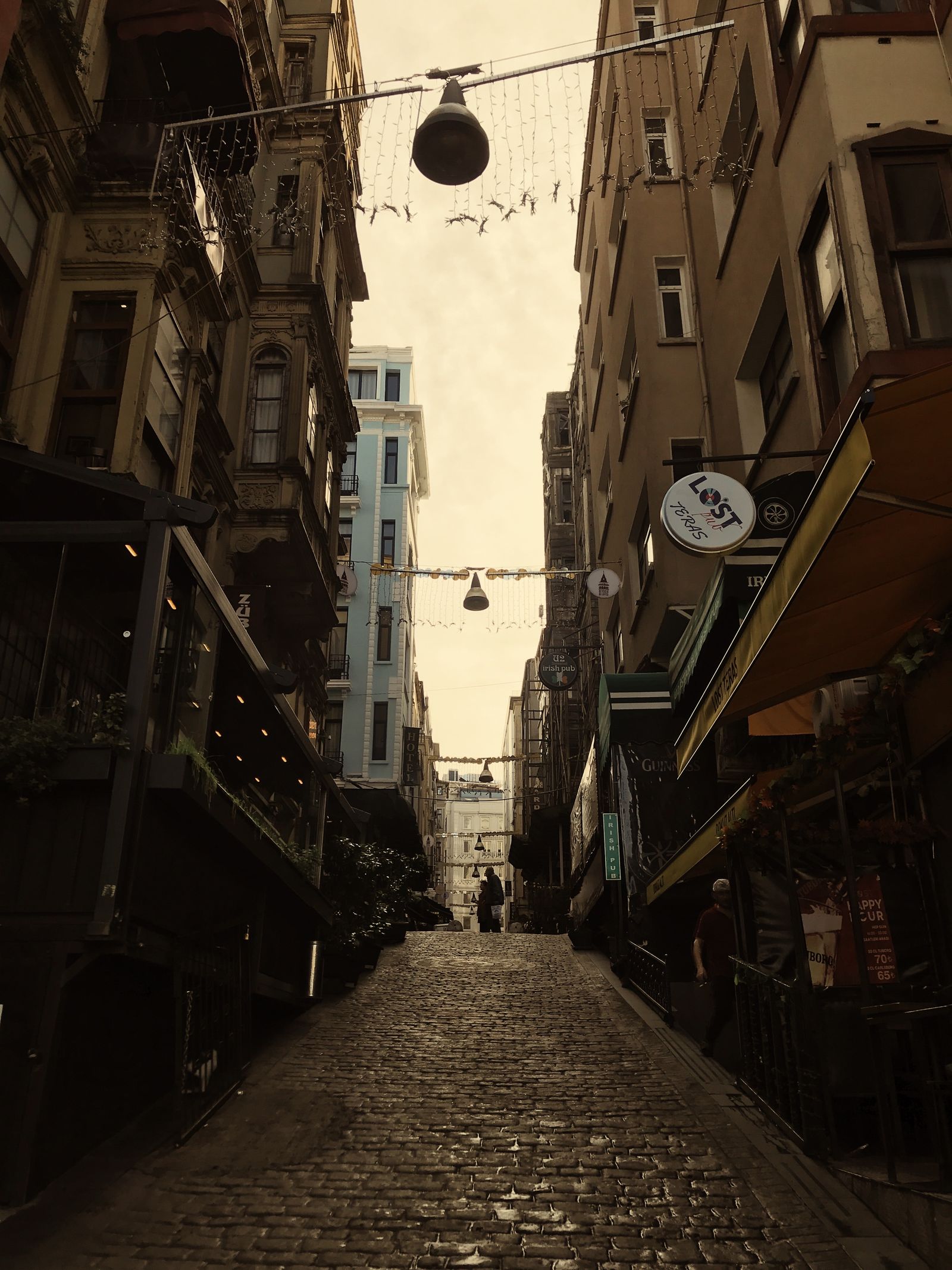 Cobblestone street lined with historic European buildings