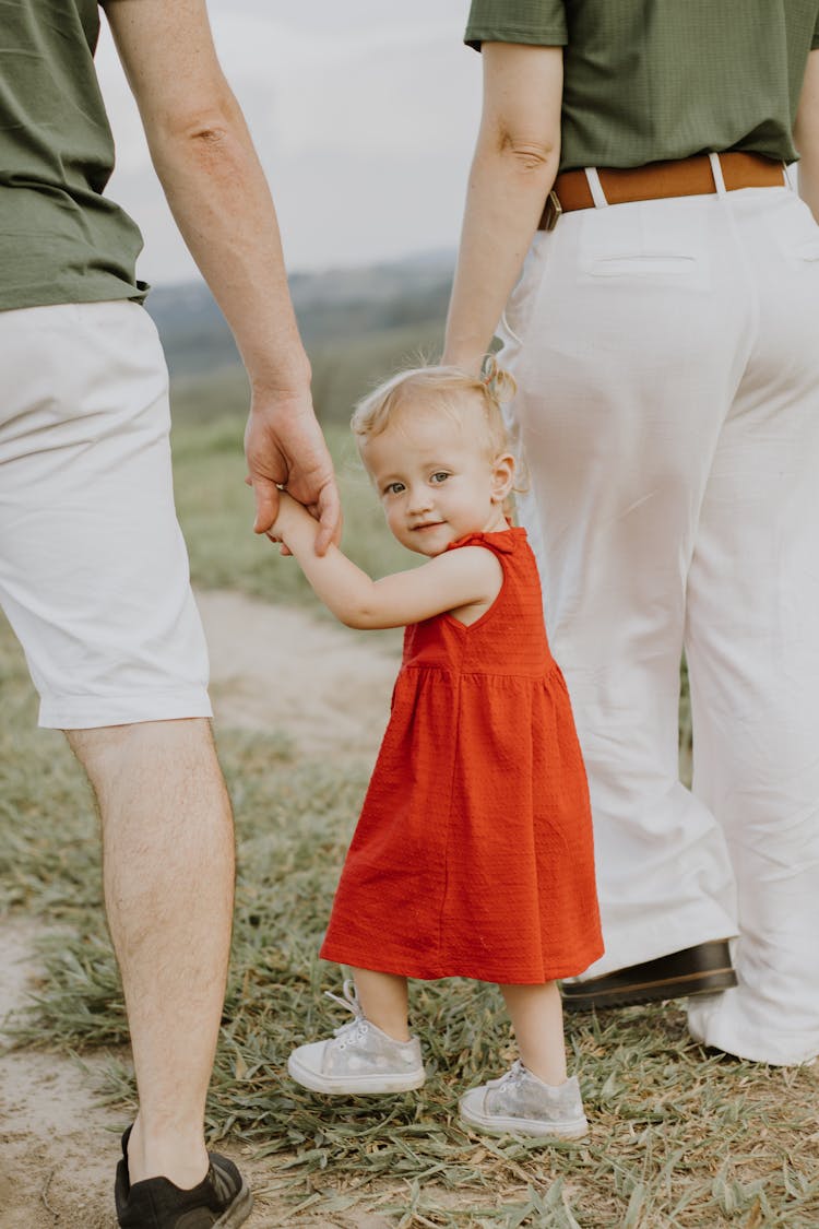 Parents On A Walk With Their Daughter 