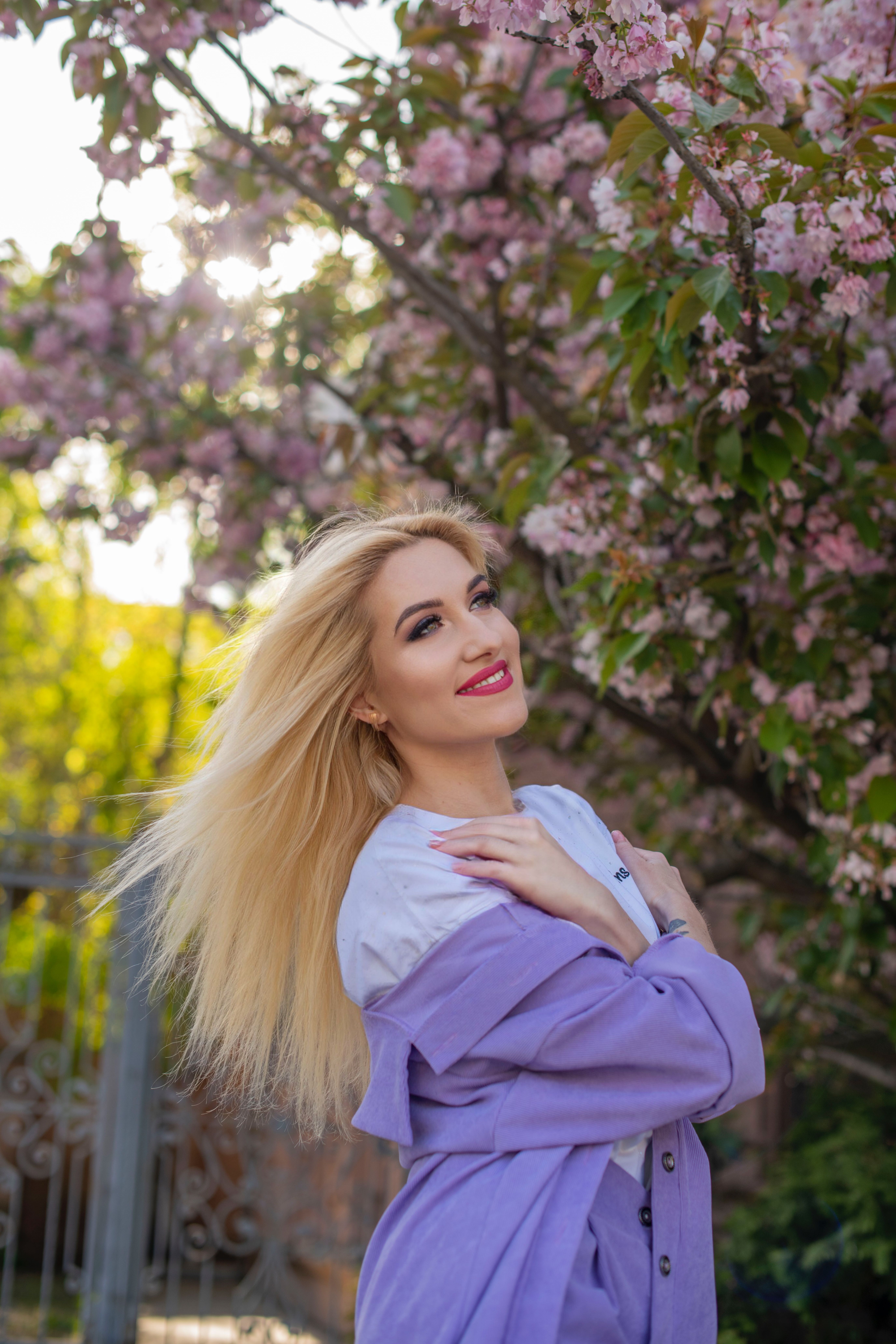 A beautiful blonde woman in a purple coat · Free Stock Photo