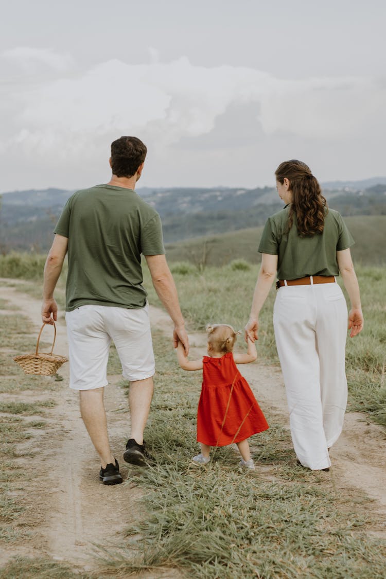 Parents On A Walk With Their Daughter