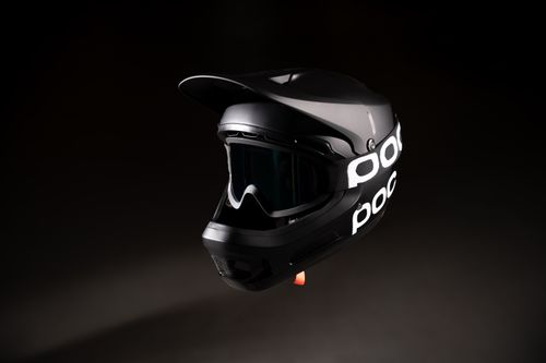 Free A sleek black bicycle helmet with goggles isolated against a dark backdrop. Stock Photo