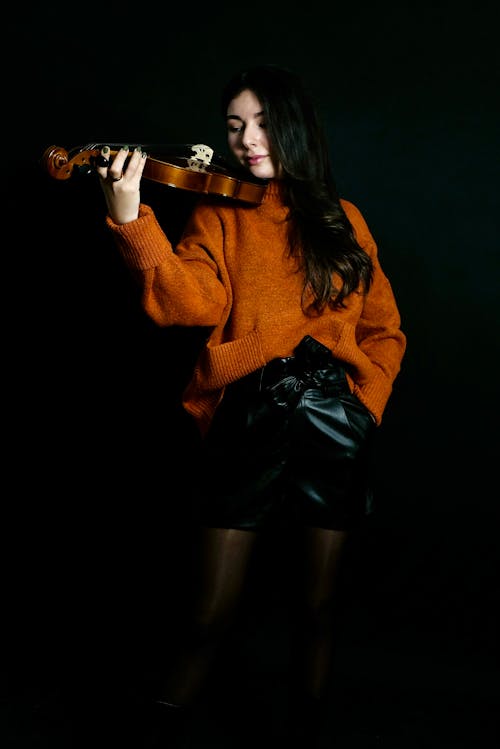 Brunette in Sweater and Shorts Posing with Violin