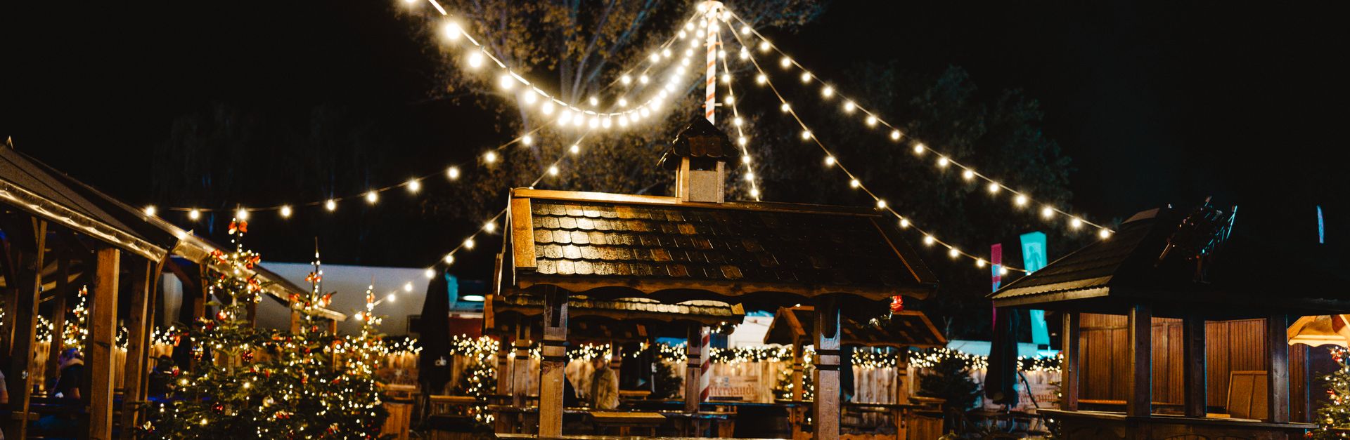 Enchanting Berlin Christmas market illuminated at night with festive decorations and lights.
