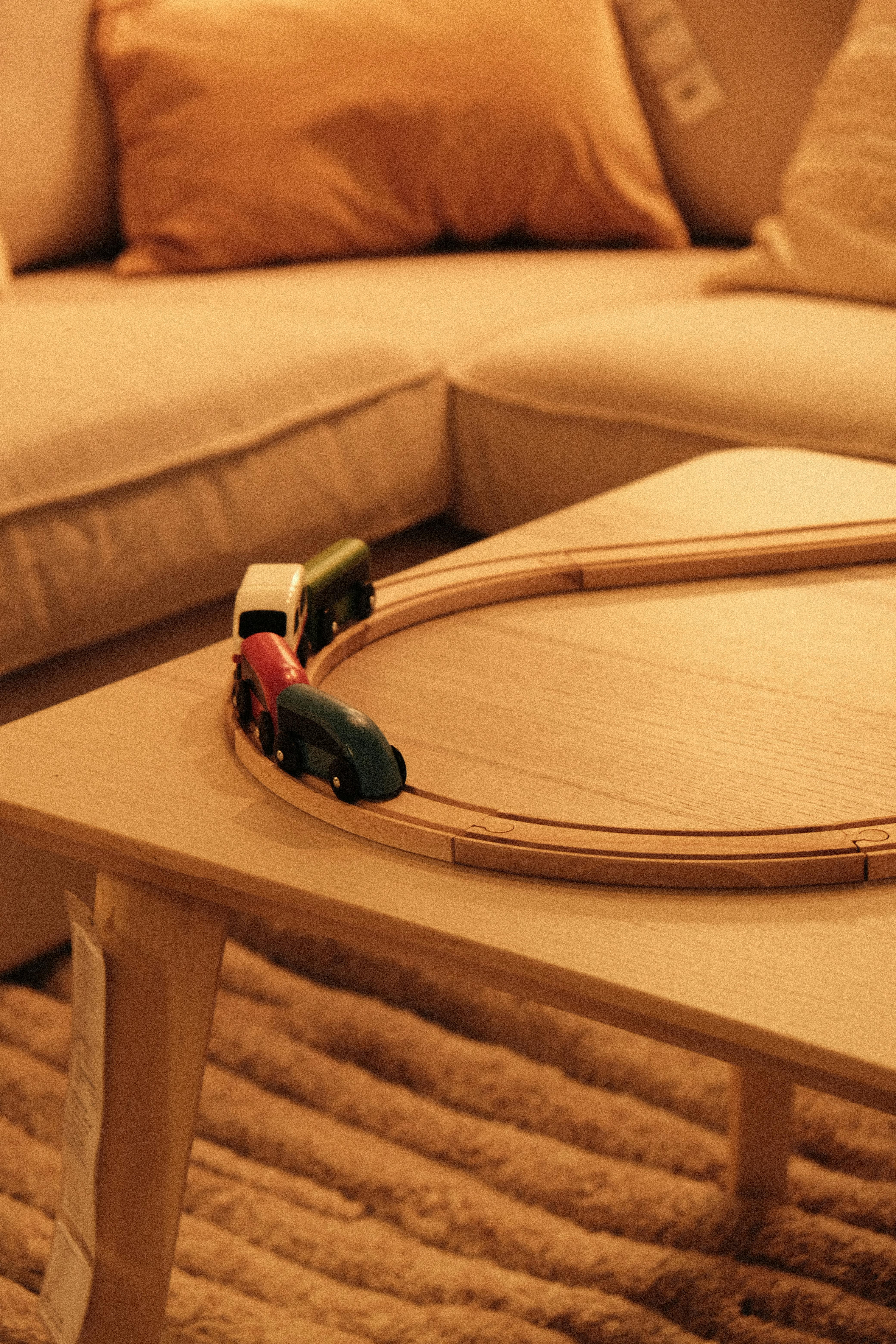 Warm-toned living room scene featuring a wooden toy train on a coffee table.