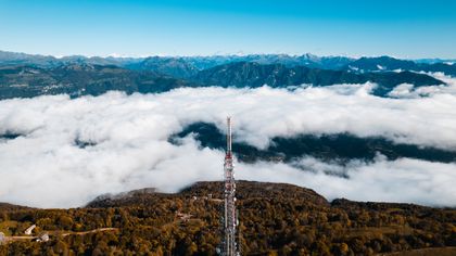 Photo by Bodisem Sameliuk on Pexels — aerial view of a ridge above a cloud layer