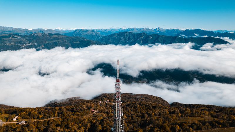 Photo by Bodisem Sameliuk on Pexels — aerial view of a ridge above a cloud layer