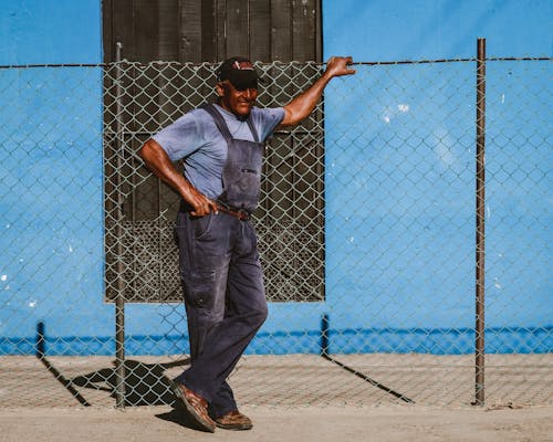 Man Wearing Dungarees on a Street