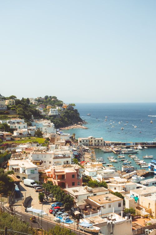 Free Picturesque view of a charming coastal town with boats along the Mediterranean shore. Stock Photo