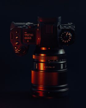 A professional DSLR camera lens in moody lighting. Perfect for photography themes.