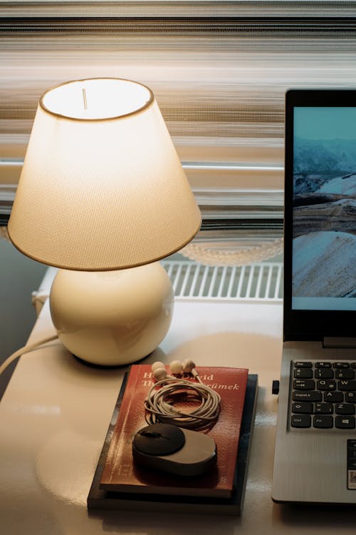 Books, Lamp and Laptop on Desk