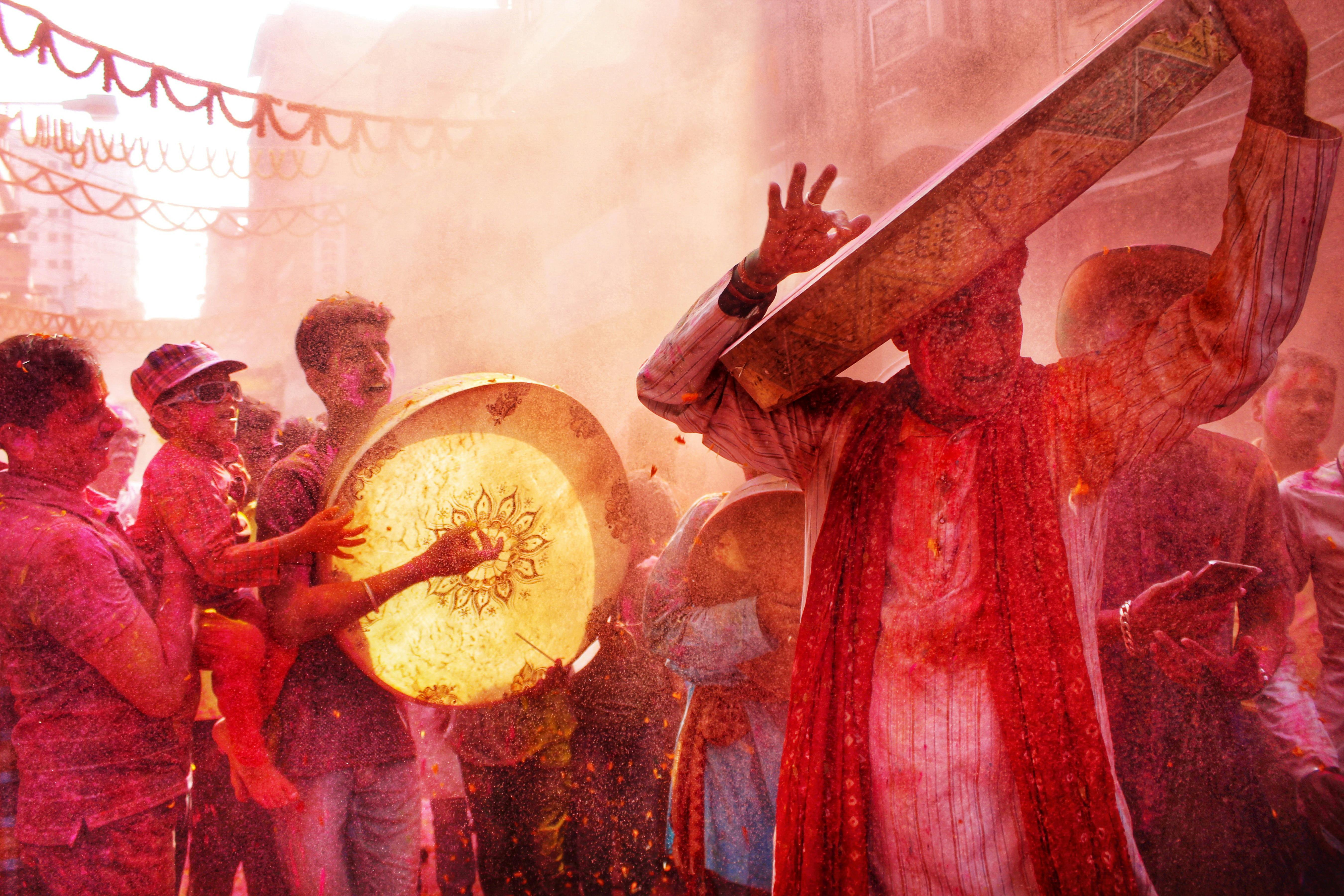 Colorful Holi festival with drums and dancing in Kolkata streets, capturing joy and tradition.