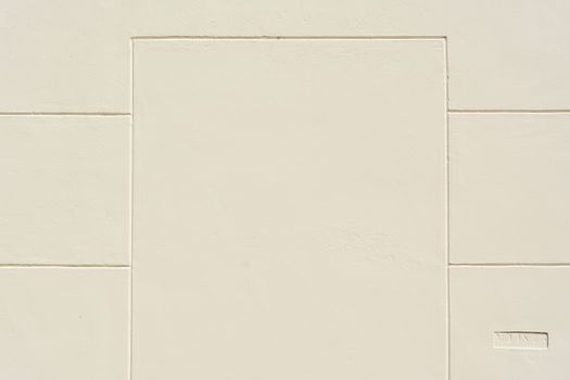 A clean beige wall featuring a minimalist geometric pattern with ample copy space.