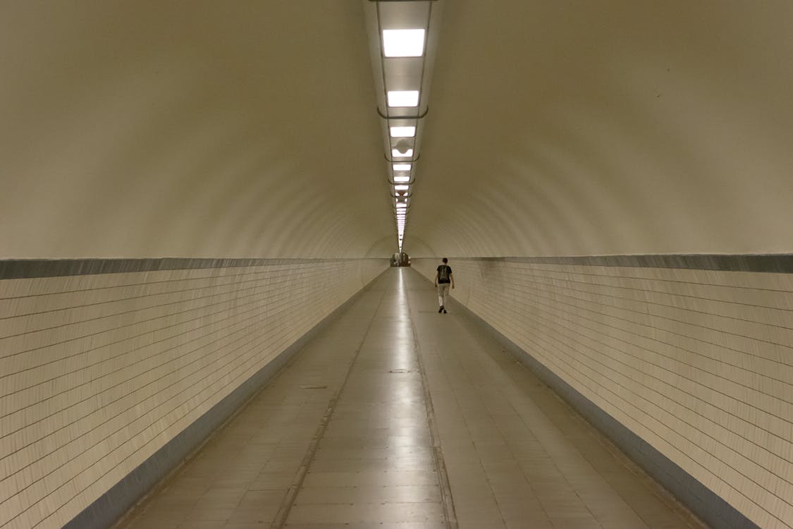 Man Walking in Tunnel on a Metro Station 