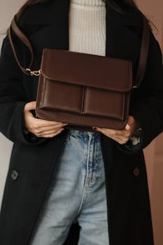 Chic leather handbag featured in a fashion portrait showcasing modern style and elegance.