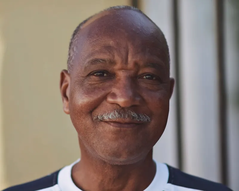 A smiling older man, relaxed and in good health