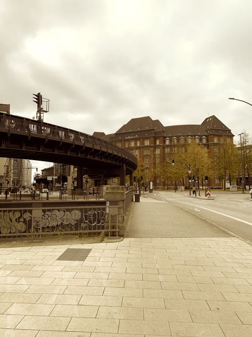 Free Amoody, empty urban street in Hamburg captured with a sepia tone, highlighting its unique architectural style. Stock Photo