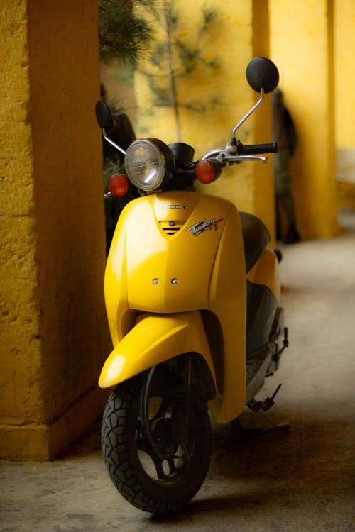 Free Yellow Scooter by Pillar Stock Photo