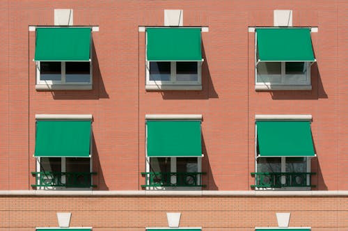 Green Awnings over Windows on Brick Residential Building