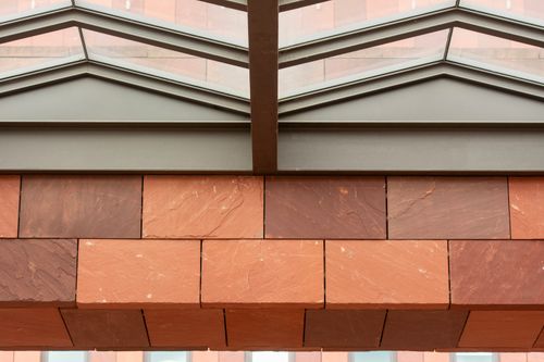 Free Contemporary architecture featuring red bricks and geometric glass ceiling design. Stock Photo