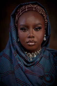 Portrait of a beautiful woman with headscarf and luxury jewelry in a studio setting.. portrait, beautiful, woman