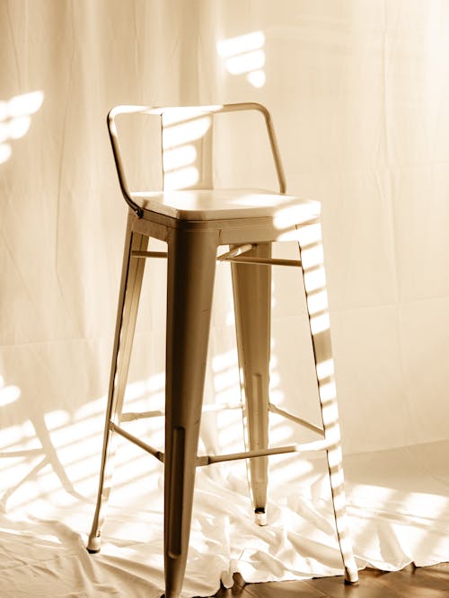 A white chair in natural sun lighting at home